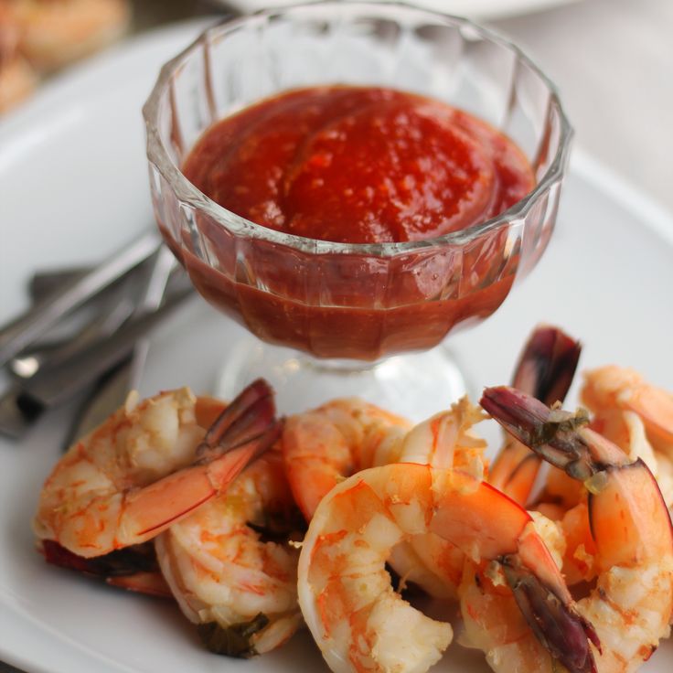 a plate with shrimp and sauce on it