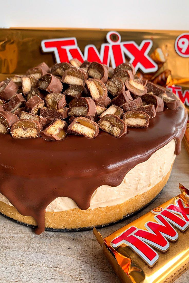 a cake with chocolate frosting and candy bars