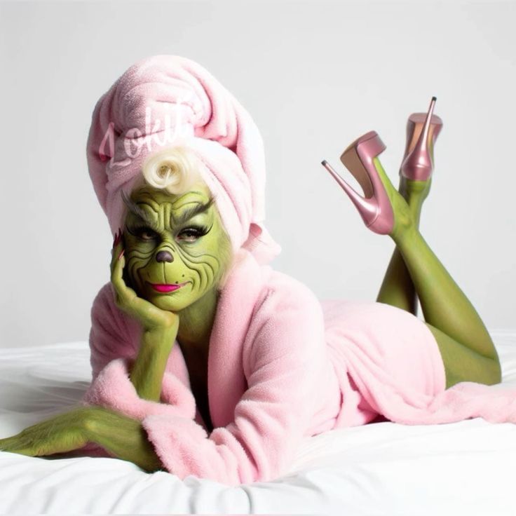 a woman dressed in green and pink is laying on a bed