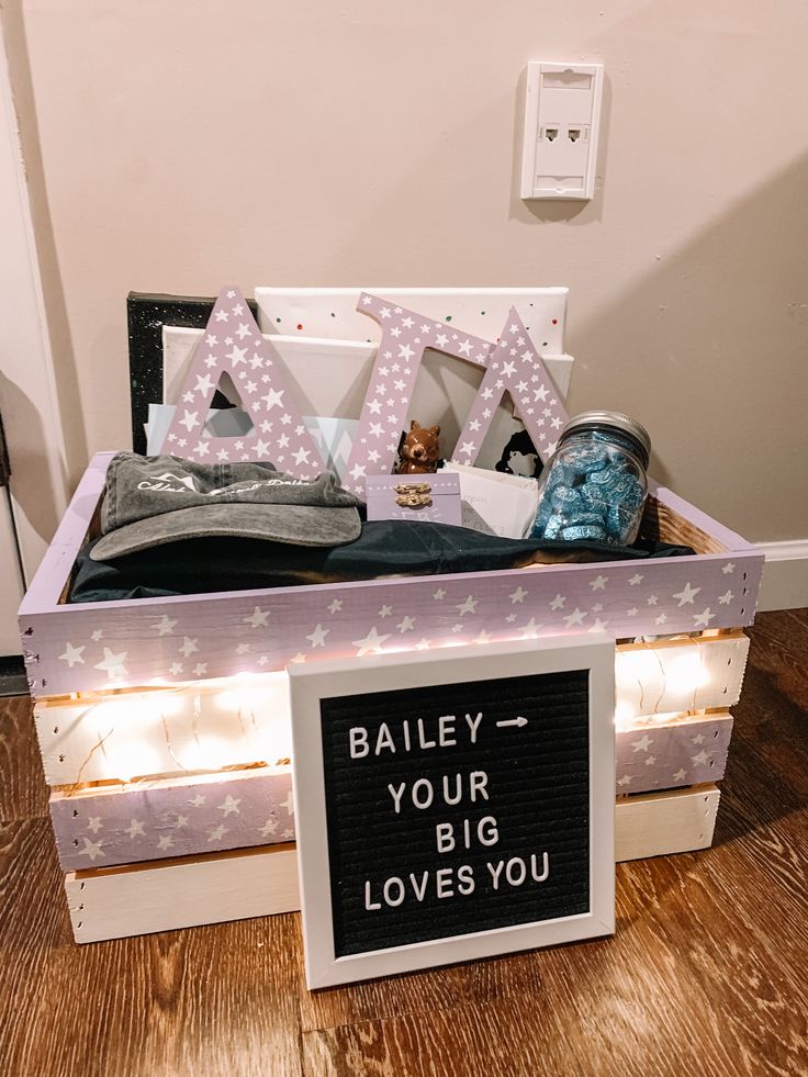 a wooden box with clothes and letters on it