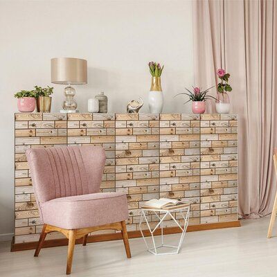 a living room with pink chairs and wooden furniture