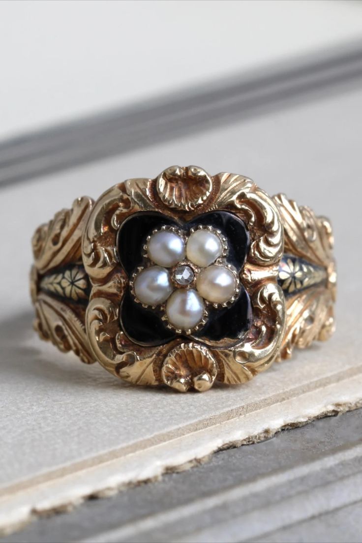 Antique yellow gold ring with black enamel and a pearl flower in the center, surrounded by a floral scroll pattern. Georgian Rings Antique, Ornate Gold Rings, Georgian Engagement Ring, Pirate Wedding, Sunburst Ring, Antique Gold Rings, Georgian Ring, Georgian Jewelry, Rings Vintage