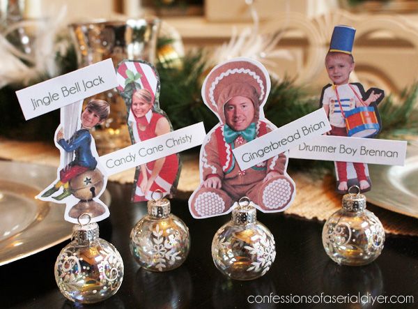 three small christmas ornaments on top of a table with place cards in front of them