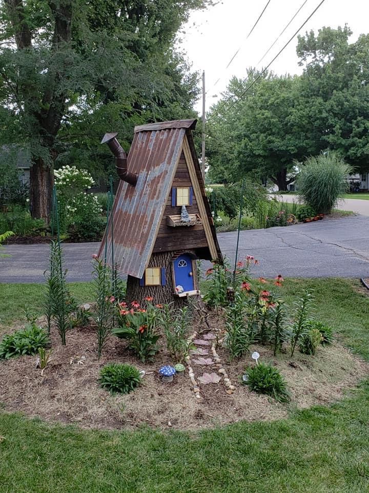 a small house made out of an old tin roof