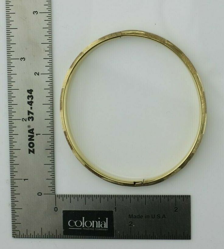 "14K Yellow Gold Hinged Bangle 2 3/8\"x2.25\" oval inside, florentine finished alternating directions, all around, Circa 1950, 8.4 grams Stock # BB207B22 This listing contains photographs of the actual item you will receive. Our items are in excellent condition with little or no signs of wear and many are one of a kind pre-owned estate finds. Please look closely at the pictures in this listing as they are part of the product description. Please read the description, as any imperfections or condi Vintage 14k Stamped Round Bangle, Antique Oval Yellow Gold Bangle, Antique Yellow Gold Oval Bangle, Antique Oval Bangle In Yellow Gold, Hinged Round Gold Bracelet For Anniversary, Gold Hinged Bracelet For Anniversary, Classic Oval Gold Bracelet Engraved, Classic Engraved Oval Gold Bracelet, Engraved Oval Yellow Gold Bracelet