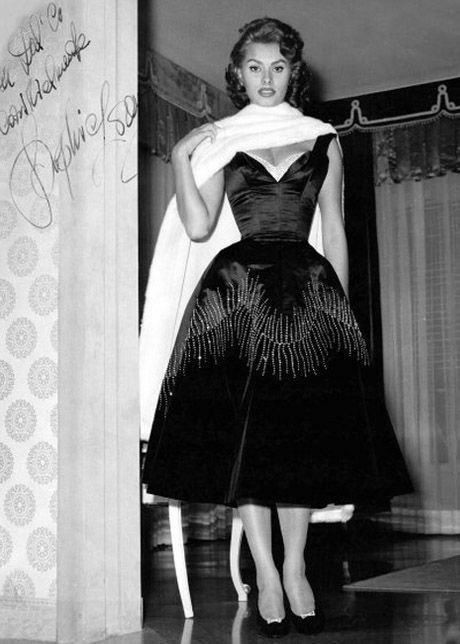 a black and white photo of a woman in a dress