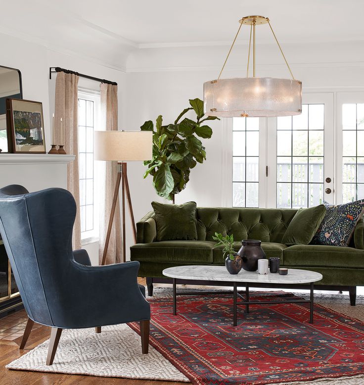 a living room filled with furniture and a large potted plant on top of a table