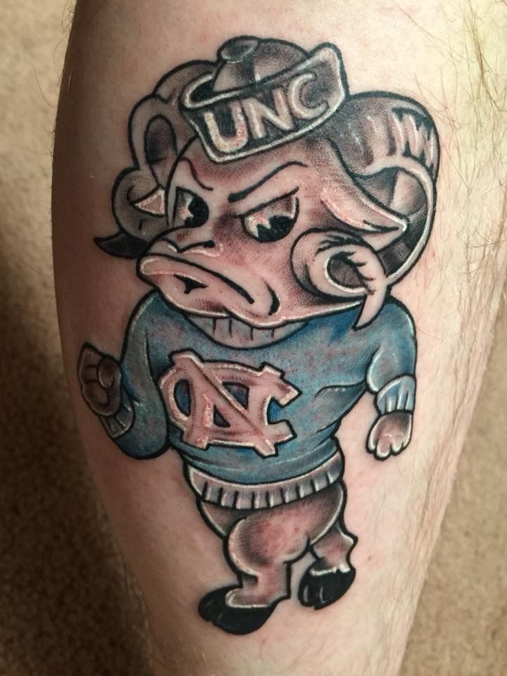 a tattoo on the leg of a man with an image of a pig wearing a baseball uniform