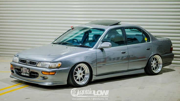 a silver car parked in front of a garage door