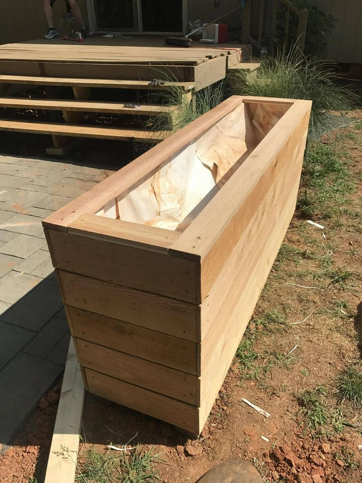 a large wooden planter sitting on top of a field