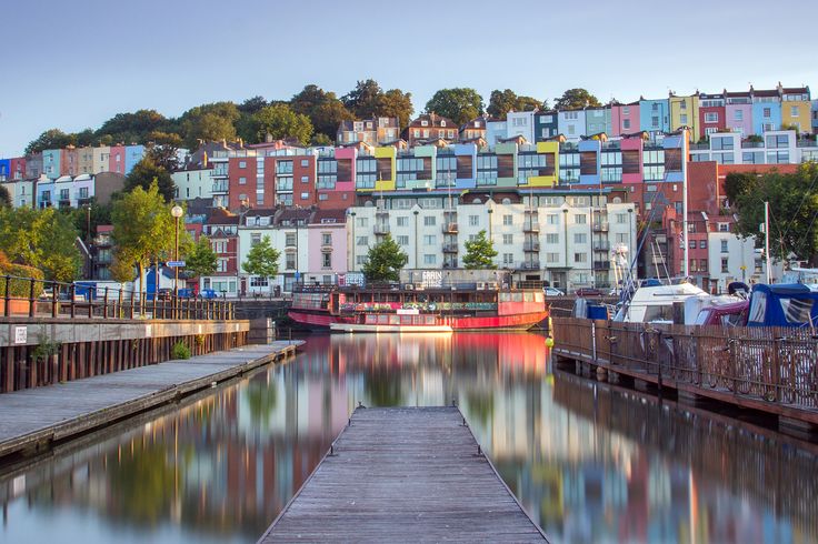 there is a long dock in front of some buildings