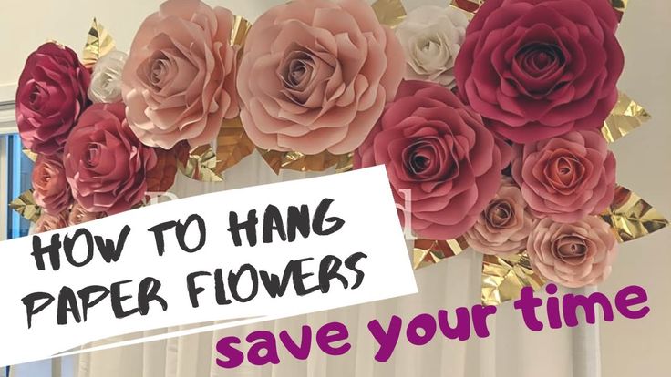 paper flowers are hanging from the ceiling with a sign that says how to hang paper flowers save your time