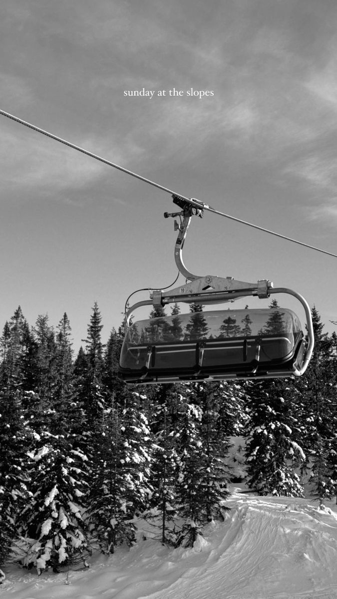 a ski lift with trees in the background