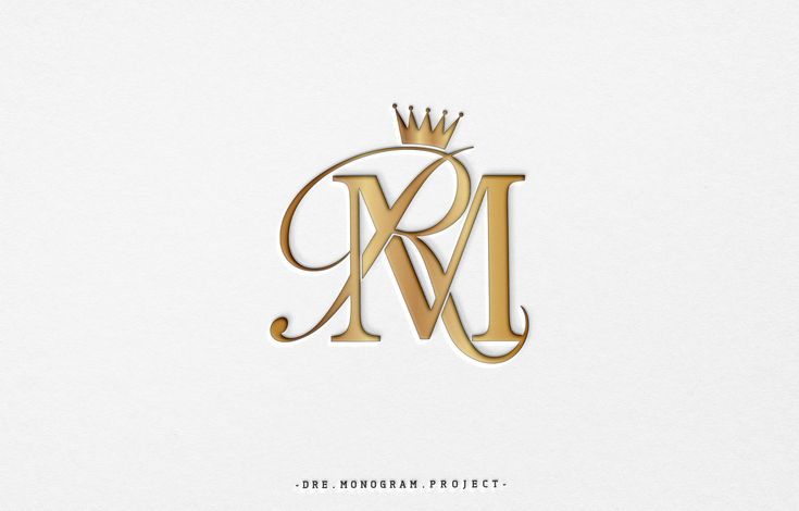 the letter m is made up of gold foil and has a crown on top of it