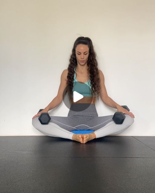 a woman sitting in the middle of a yoga pose