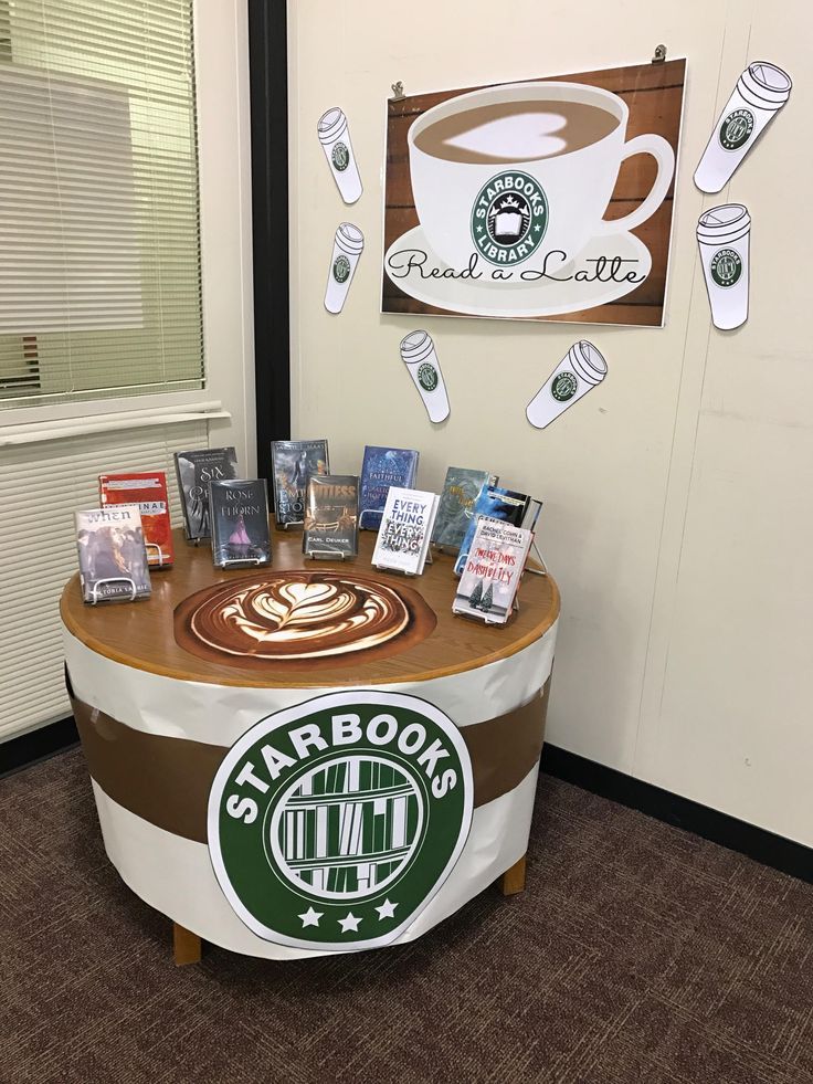 there is a table with coffee on it in the corner of an office cubicle