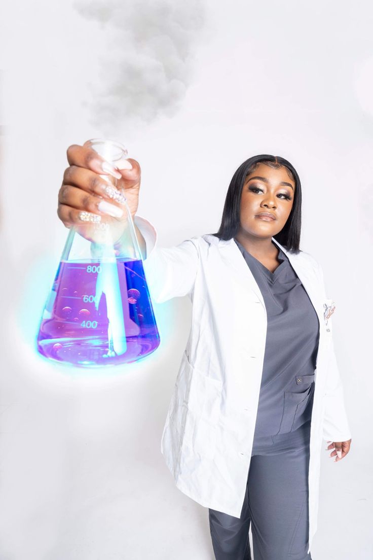 a woman in white lab coat holding up a purple flask