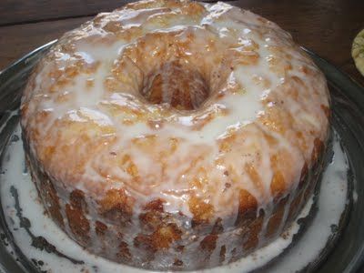 a glazed bundt cake sitting on top of a glass plate