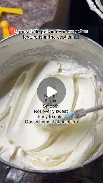 a bowl filled with white frosting on top of a counter