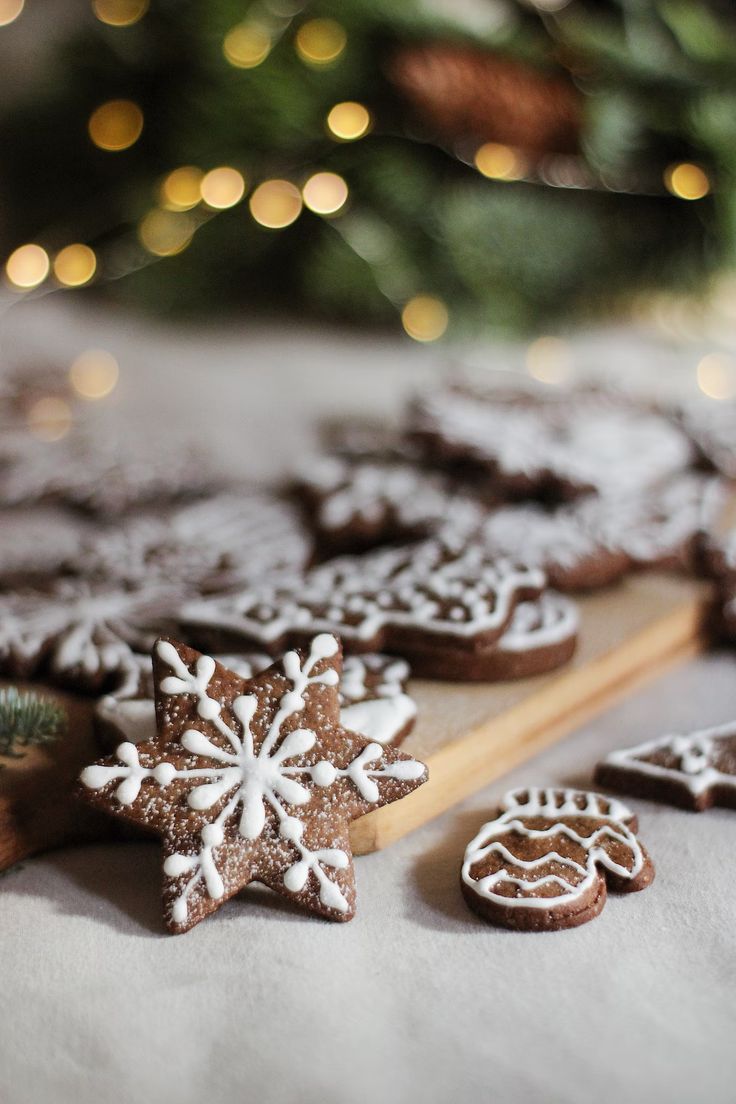 some cookies are laying on a table next to a christmas tree