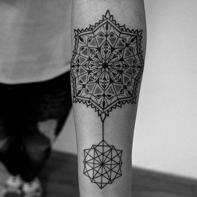 a black and white photo of a tattoo on the leg