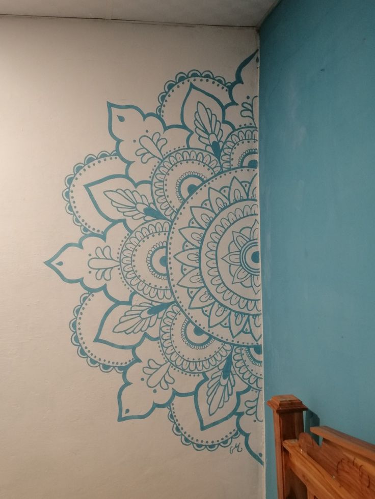 a blue and white wall with a wooden bench