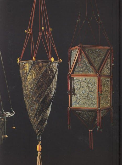 three hanging objects in different colors and designs on a black background, one with gold accents