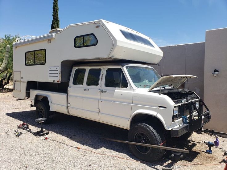 a white truck with a camper attached to it