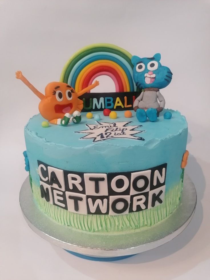 a birthday cake with cartoon characters on top and rainbow in the background for an individual's special occasion