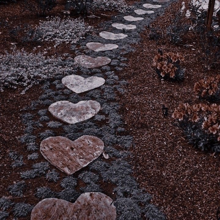 a path made out of stepping stones with hearts painted on them