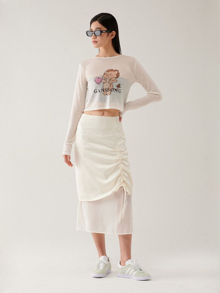 Editor's Notes This skirt is made of polyester and rayon. This skirt has an elegant design such as shirring detail, you can adjust the shirring by using the string. Wear this item with a solid blouse and mules for a feminine mood. - Classic design midi-length skirt- Layered detail with contrast fabric- H-line and a shiny fabric detail- Must-have item and a stylish item Measurements(in.)Size (S/M) - Total Length: 30.51 in. / 31.10 in. - Waist: 13.38 in. / 14.17 in. - Hip: 18.11 in. / 18.90 in. - Hem: 19.68 in. / 20.47 in. *Model info: Yealin Lee / Height 5' 70, Bust 30 in., Waist 22 in., Hip 33 in., Wearing S or One size Composition & Care- Shell 1: 58% Polyester 42% Rayon- Shell 2: 100% Polyester- Dry cleaning recommended- Do not b Long Skirt With Ruched Sides For Spring, Ruched Draped Skirt For Spring, Relaxed Ruched Draped Skirt For Spring, Spring Ruched Draped Skirt, Ruched Long Draped Skirt For Spring, White Tiered Skirt With Drawstring, Spring Ruched Draped Long Skirt, Spring Asymmetrical Skirt With Ruched Sides, White Long Ruched Skirt