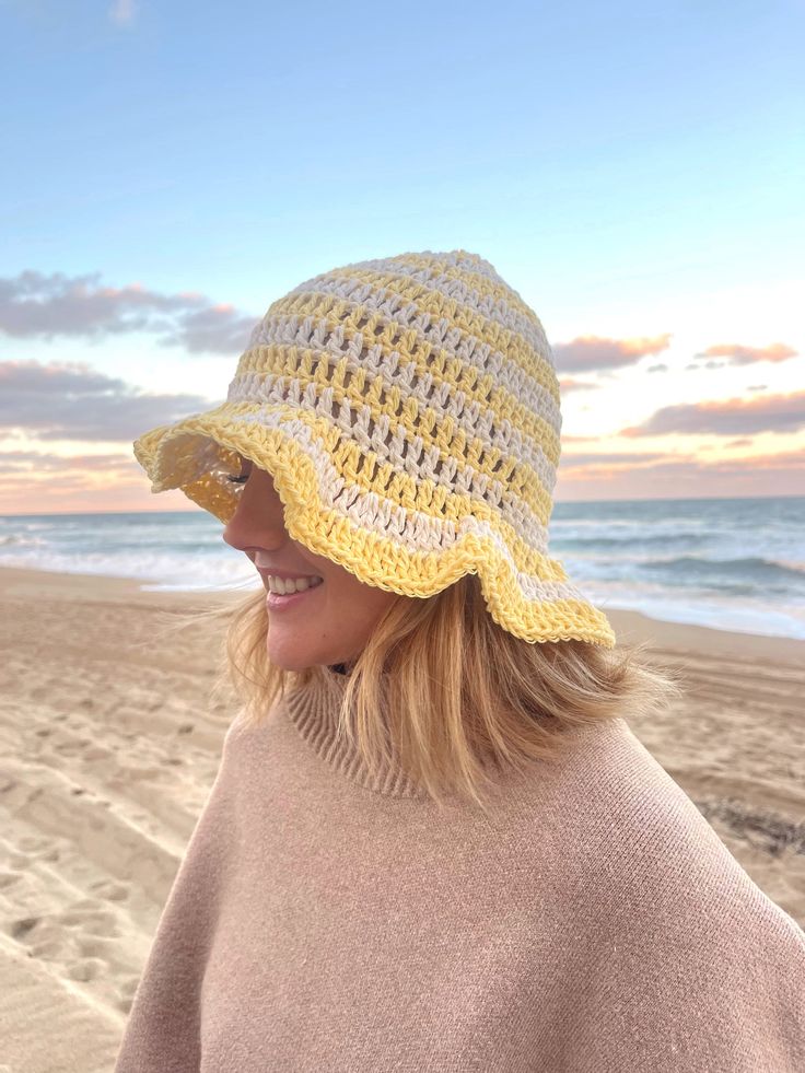 This crochet bucket hat is made by hand! The material is light and soft so perfect for a day at the beach, a fashion piece and even to keep you warm. Spring Beach Cloche Hat One Size, Spring Beach Knitted Cloche Hat, Spring Knitted Cloche Hat For Beach, Casual Beach Cloche Hat, Cotton Sun Hat, Hand-knitted Crochet Hat For Beach, Beach Crochet Hat Hand Knitted, Summer Knitted Brimmed Cloche Hat, Crochet Bucket Hat For Beach Season