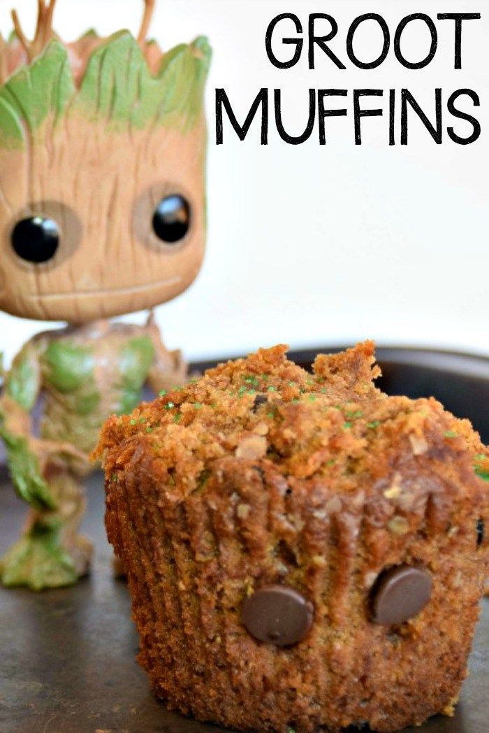 a close up of a muffin on a plate with a small toy next to it