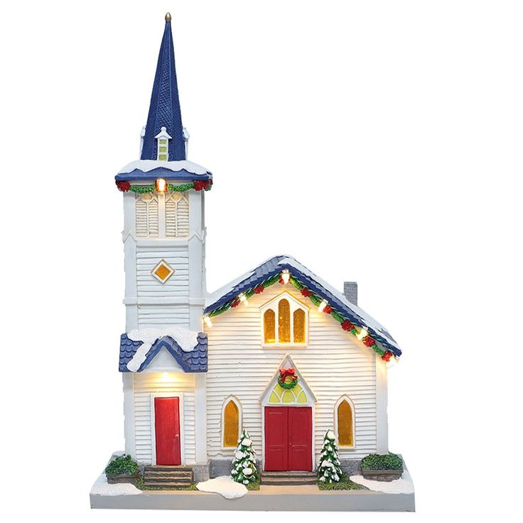 a small white church with red doors and lights on it's steeple is decorated for christmas