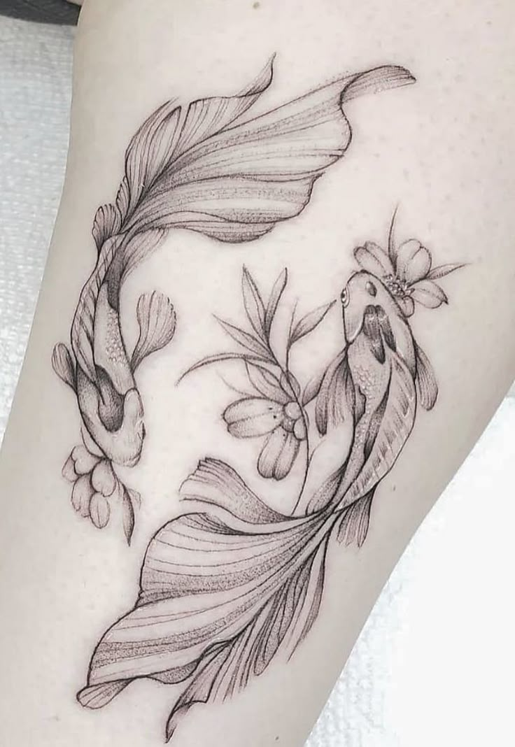 a black and white photo of a fish with flowers on it's side leg