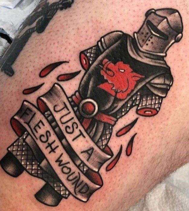 a tattoo on the back of a man's leg with an image of a knight