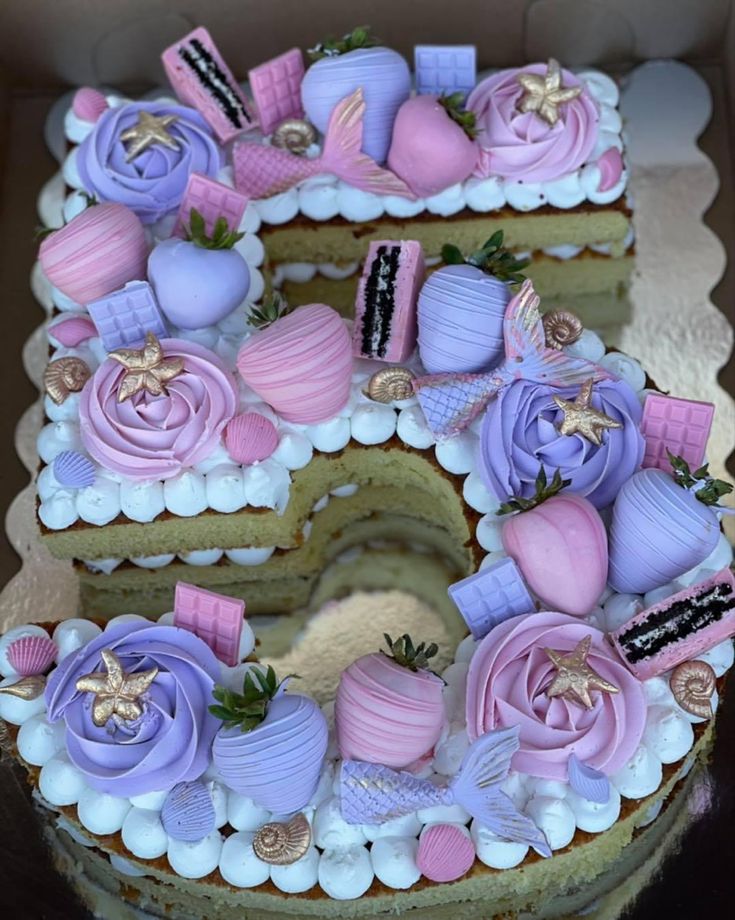 a cake that is shaped to look like the number five with pink and purple decorations