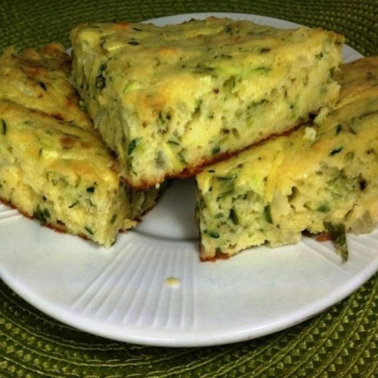 four pieces of quiche on a white plate