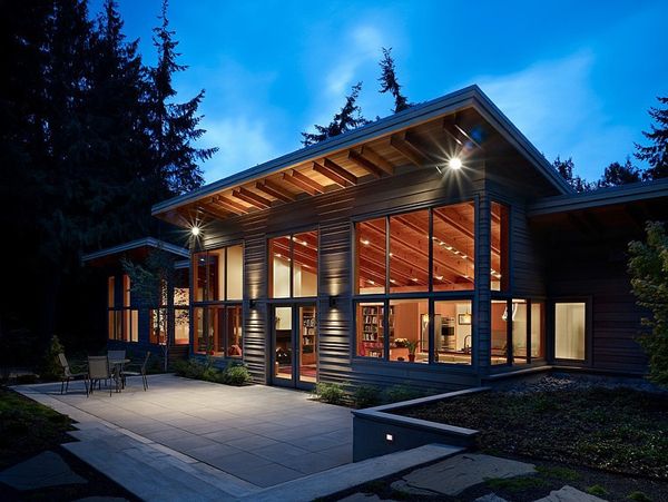 a modern house lit up at night in the evening