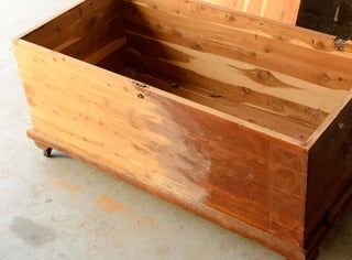 a wooden box sitting on top of a cement floor