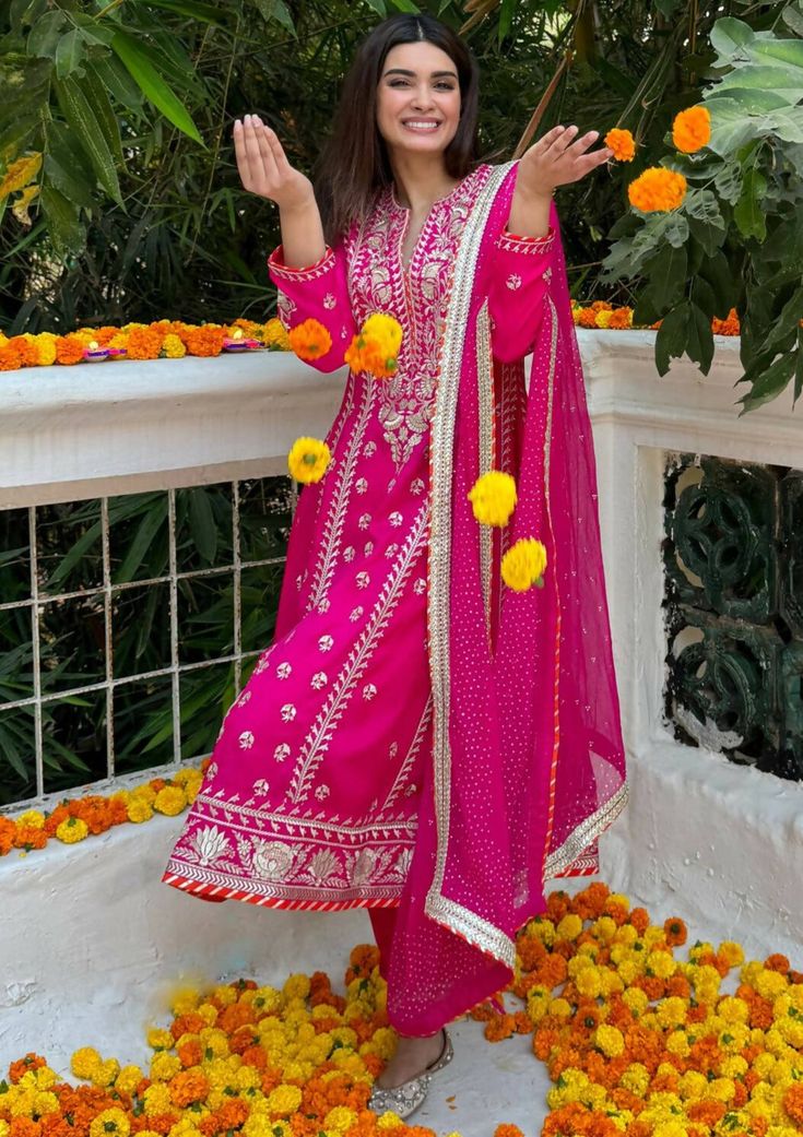 This anarkali, paired with a churidar and a beautiful dupatta, features flowing kalis down the waistline, adding a playful and versatile touch for any occasion. .This is our signature Gopi Vaid ensemble Festive Navratri Lawn Suit With Dabka Work, Festive Pink Lawn Suit With Gota Work, Designer Dabka Churidar For Navratri, Pink Chinon Lawn Suit For Diwali, Designer Pink Lawn Suit For Festivals, Festive Lawn Suit With Zari Work For Navratri, Festive Lawn Suit With Dupatta For Diwali, Festive Pink Chinon Lawn Suit, Pink Anarkali Set With Dabka In Chinon