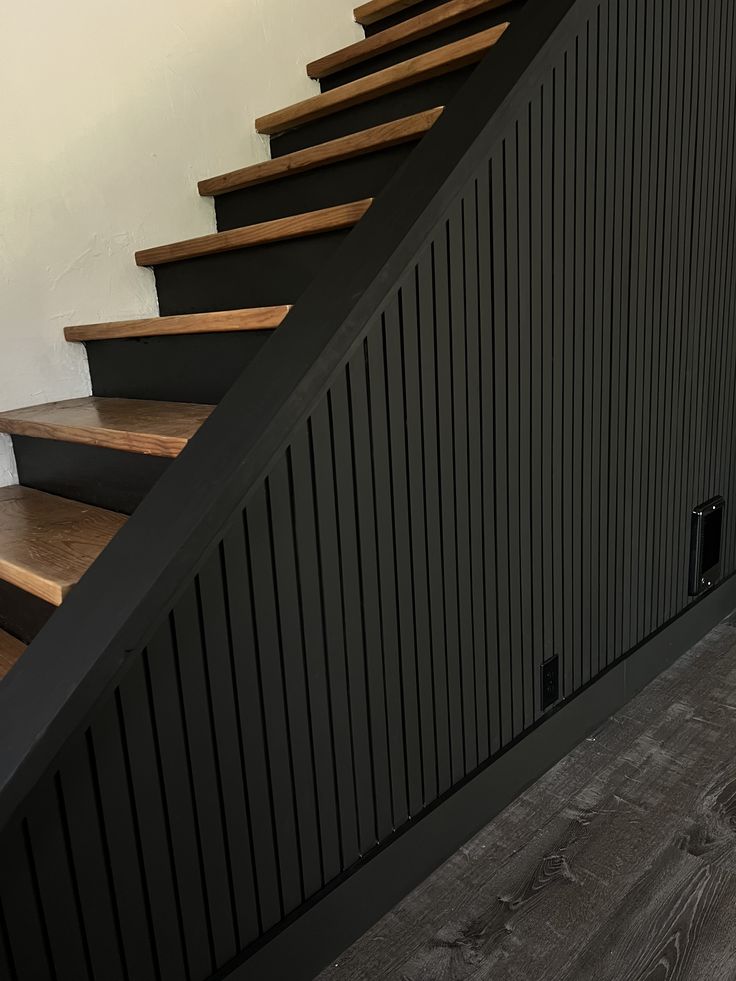 there is a black stair case on the wall