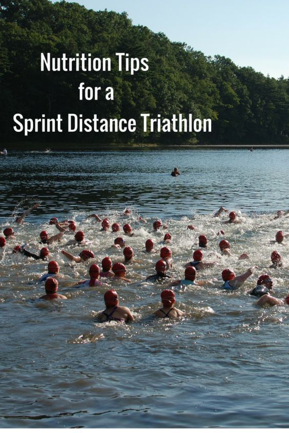 a group of people swimming in the water with text overlay reading nutrition tips for a sprint distance triathlon