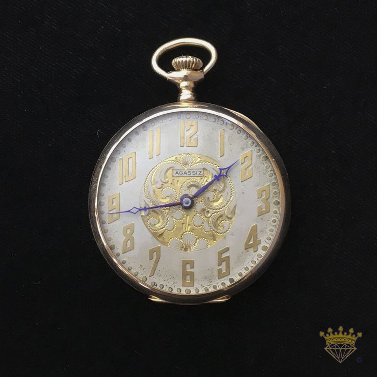 Agassiz Swiss Pocket Watch open-faced 14kt yellow gold case 17 jewels 6 adjustments 40.60mm movement, lignes 18 Swiss Vibrant blue hands Serial # 122035 Case: ROY 14k FINE 585/1000 A very rare find. This Agassiz displays an incredibly fine detailed dial, unlike any other we can find online. The backplate of the case has some dings and creases that have been cleaned and straightened as well as it can (as pictured). Recently serviced in store by our own Watchmaker, Robert Rasmussen, RJR Watches 40 Antique Yellow Gold Chronometer Watch, Antique Yellow Gold Watch Accessories With Subdials, Self-winding Yellow Gold Pocket Watch, Self-winding Yellow Gold Pocket Watch With Round Dial, Victorian Yellow Gold Formal Watches, Formal Yellow Gold Medallion Watch, Gold Chronometer Watch Timeless Style, Antique Yellow Gold Watch With Round Dial, Gold Jewelry And Watches With Chronometer