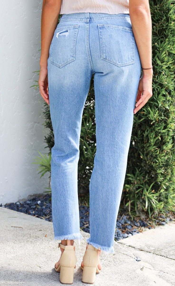 The Distressed Raw Hem Mom Jeans are a chic blend of vintage and contemporary fashion. With their high-rise waist, they offer a comfortable and flattering fit that harks back to the iconic mom jean style. The distressed and raw hem detailing adds a touch of casual, edgy charm, making these jeans a versatile choice for creating a fashion-forward look that exudes confidence and personality. -Mom style jean -High rise -Rise: 11 1/8" -Inseam: 27" -Leg opening: 13" -Distressed detail -Raw hem -100% c High Rise Distressed Bottoms For Everyday, Everyday High Rise Distressed Bottoms, Distressed Mid-rise Bottoms For Everyday, Everyday Distressed Mid-rise Bottoms, Mid-rise Distressed Bottoms For Everyday, Everyday Mid-rise Distressed Bottoms, High Rise Washed Blue Distressed Cropped Jeans, Distressed High Rise Cropped Jeans In Washed Blue, High Rise Distressed Washed Blue Cropped Jeans