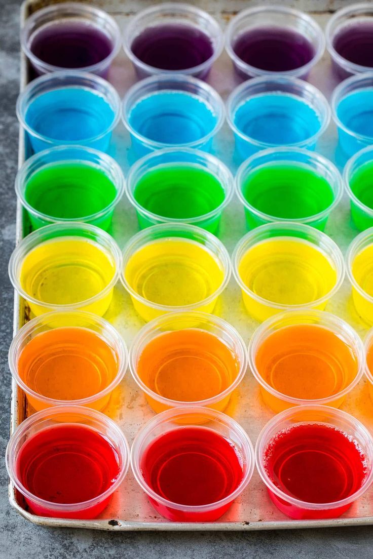 an assortment of different colored paints in plastic containers