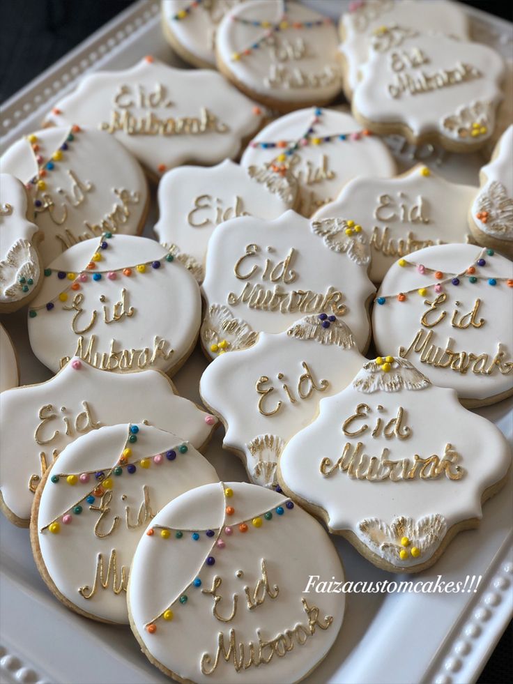 decorated cookies are on a platter with confetti