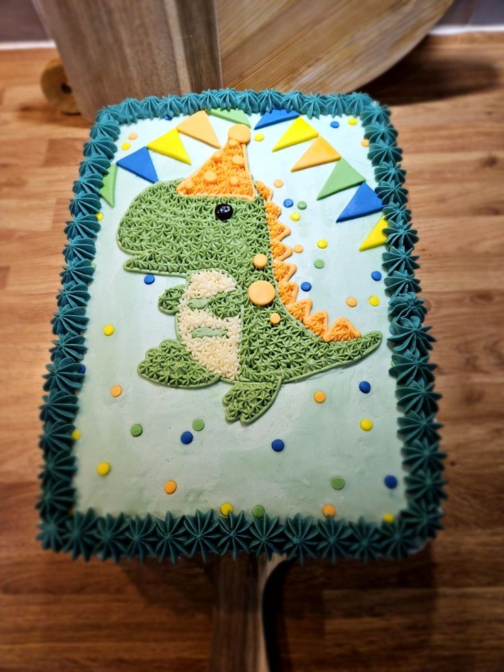 a birthday cake that looks like a dinosaur