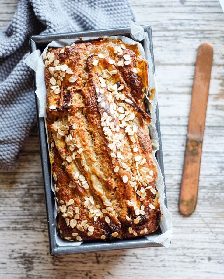 a loaf of bread sitting on top of a table next to a knife and fork