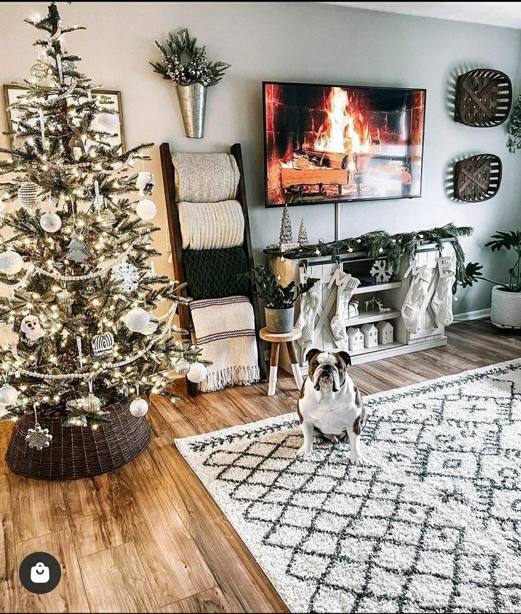 a dog sitting in front of a christmas tree